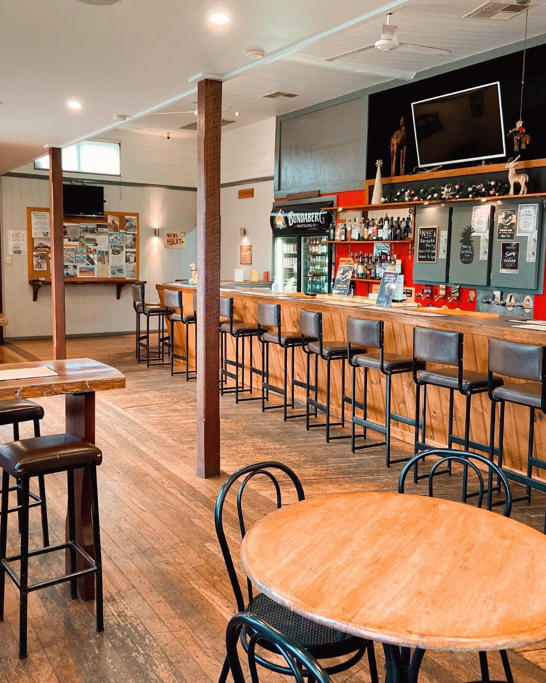 A country bar with rustic charm complete with timber floors, stools and a well-stocked bar.